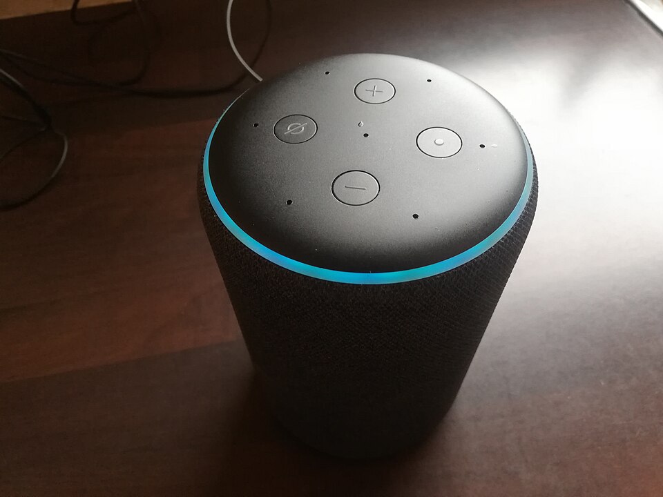 Amazon Echo smart speaker with blue LED ring illuminated