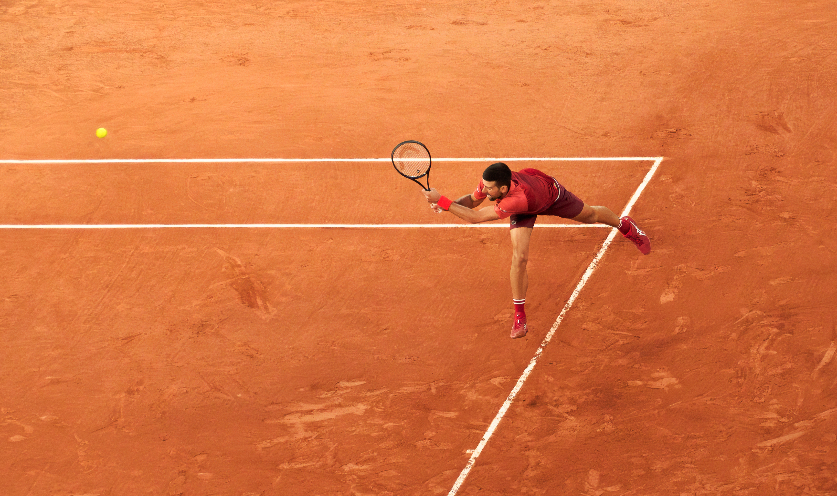 Tennis match in progress at Roland Garros clay court
